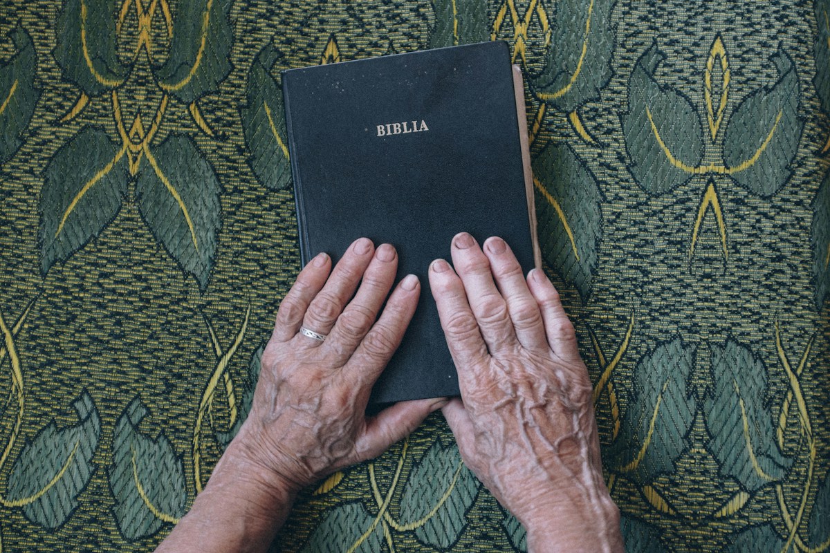 Hands resting on a Bible